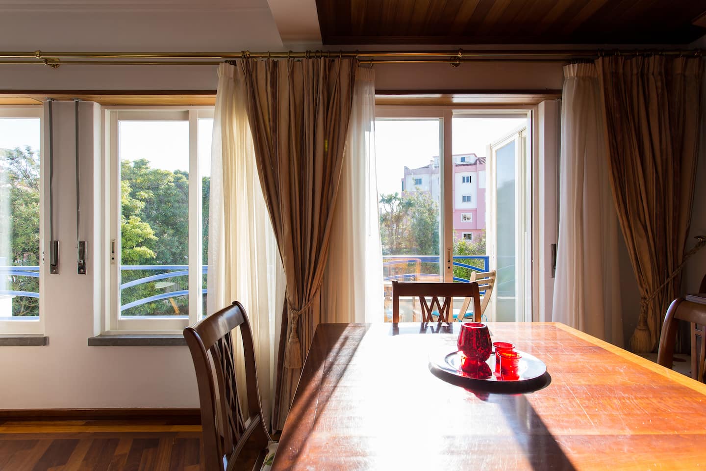 Dining table in afternoon sunlight beside the balcony