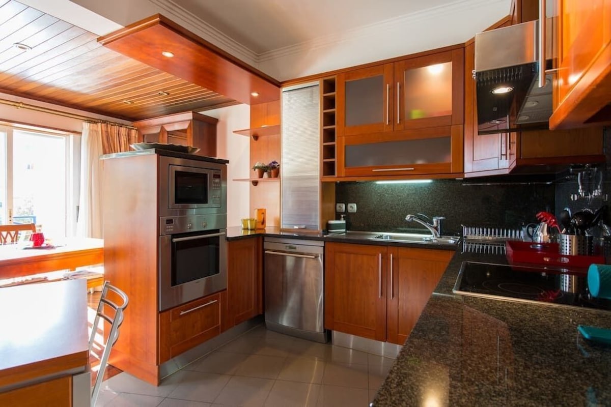 Wide view of the fully equipped warm wood kitchen
